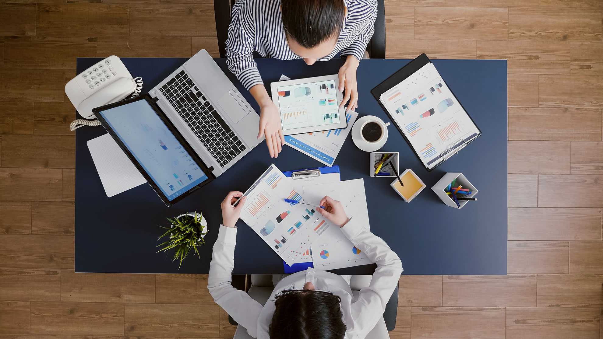 top-view-of-business-women-comparing-financial-gra-2022-02-14-14-37-35-utc-1980